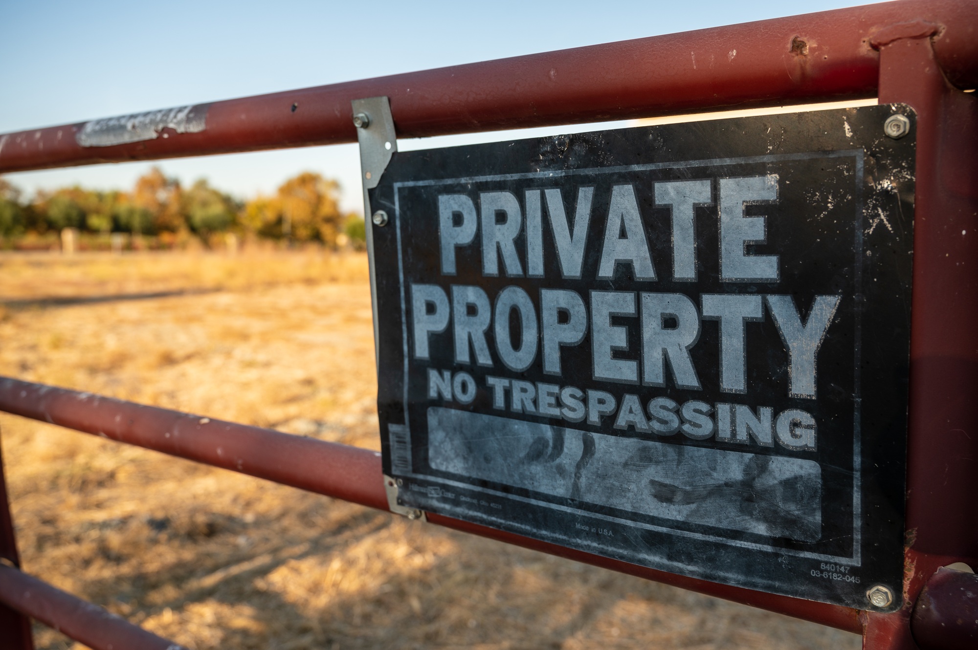 Closeup of a warning sign of private property on a black metal